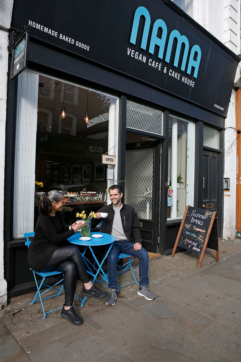 Cozy outdoor café with blue tables, perfect for casual meetings and networking events.