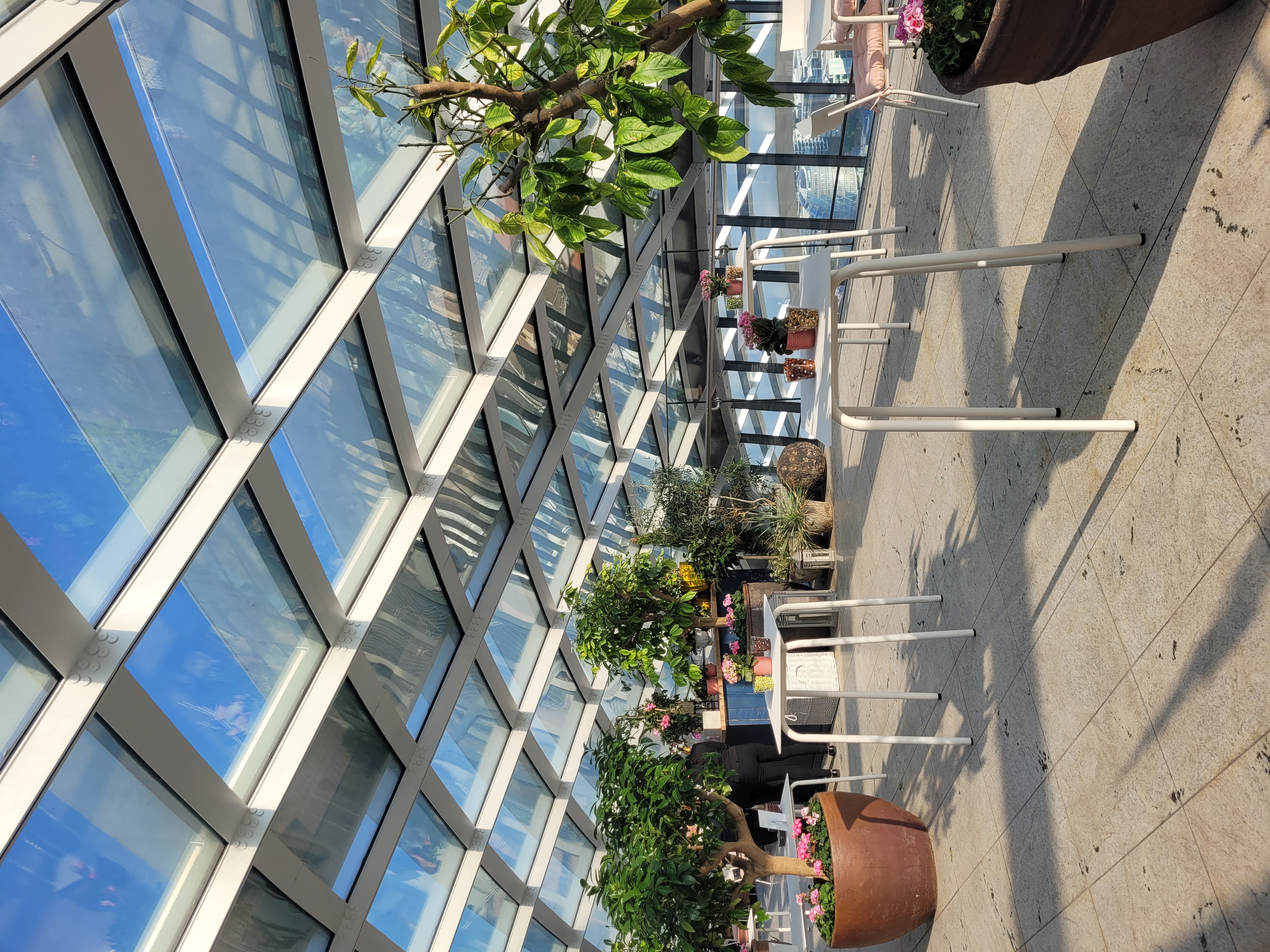 Fenchurch Terrace in Sky Garden London, bright event space with glass ceiling for gatherings.