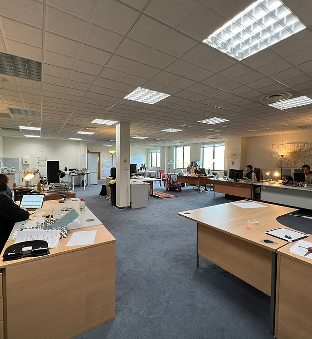 Modern collaborative office space in London with open workstations for meetings and events.