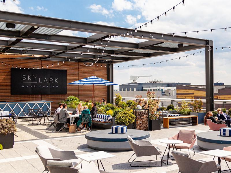Vibrant rooftop pizza restaurant with stylish seating, perfect for events and gatherings.