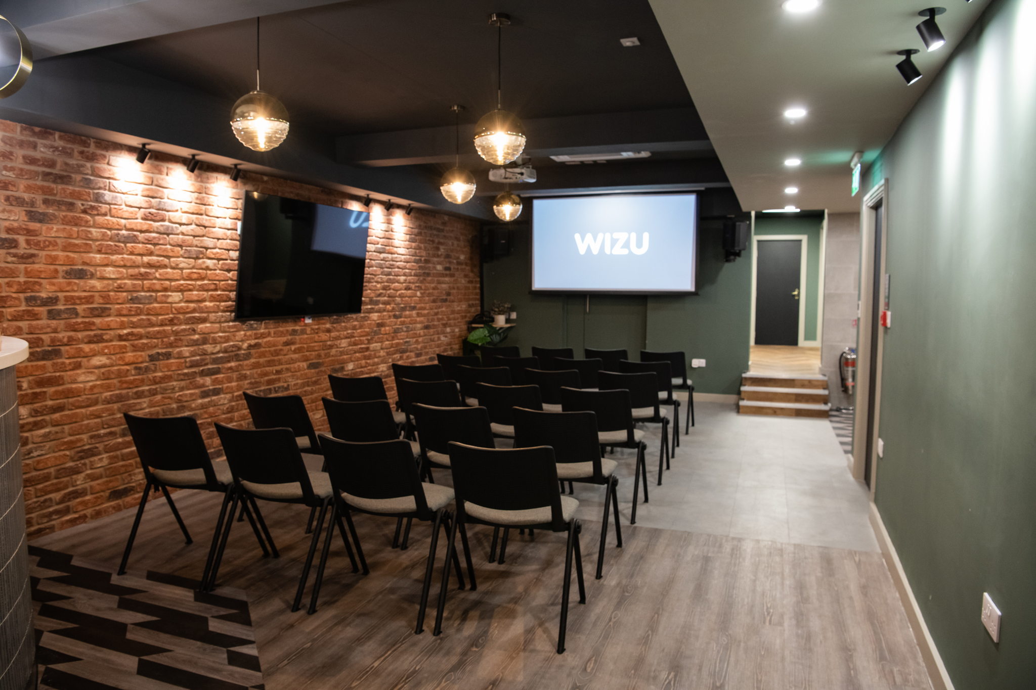Modern meeting space with brick wall for corporate events and workshops at Park Place.