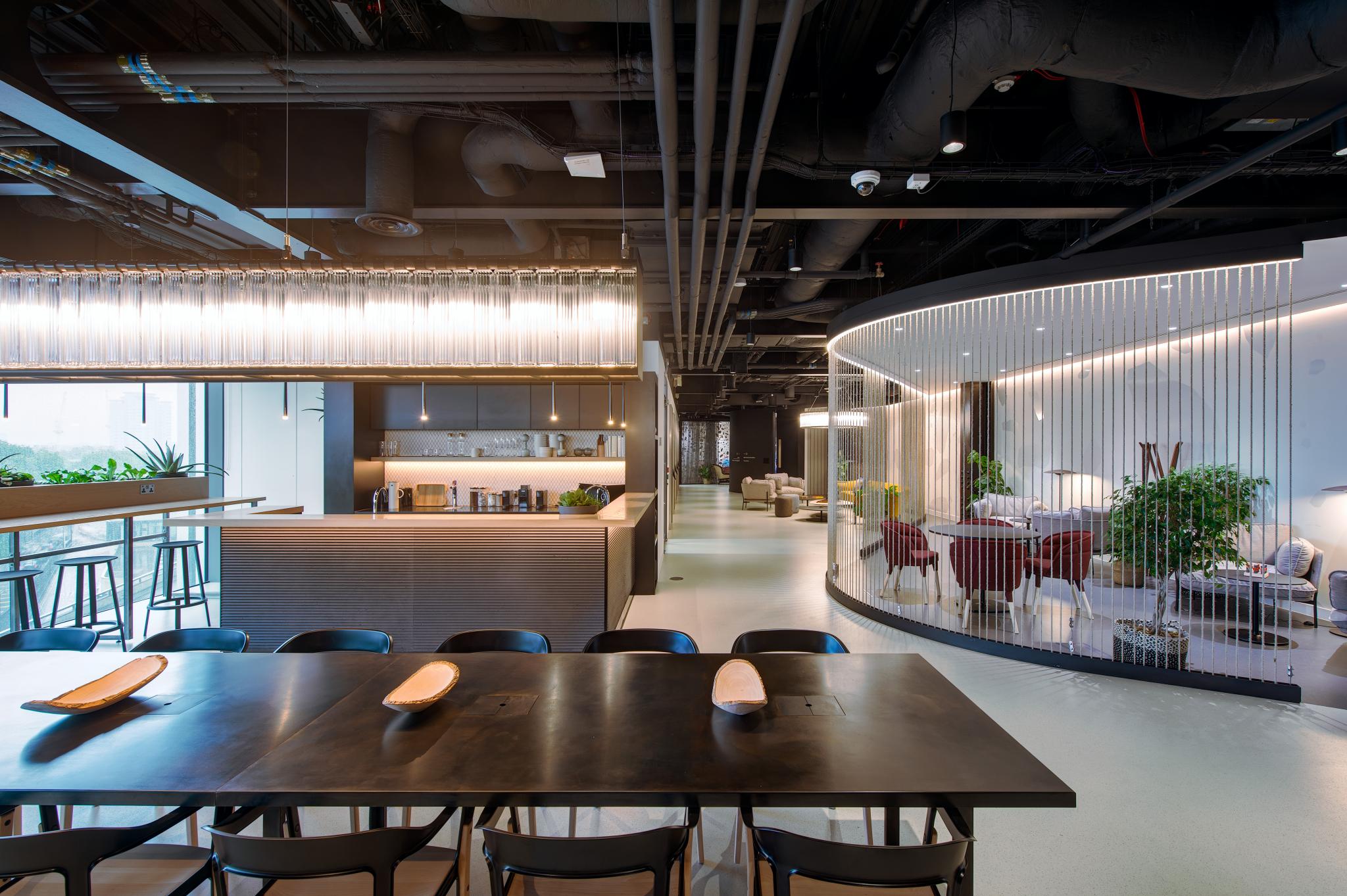 Modern dining room with long table, ideal for corporate events and team-building activities.