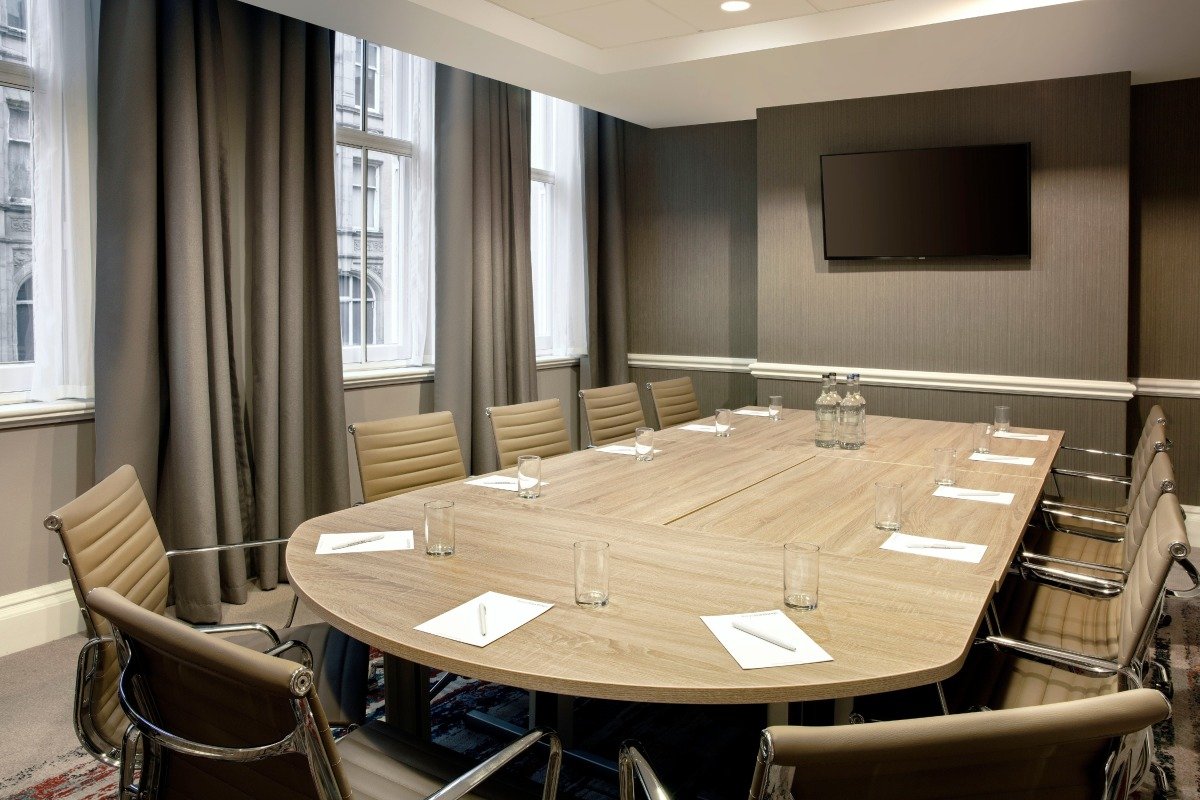 Wedgewood Suite meeting room in Leonardo Hotel Cardiff with oval table and natural light.