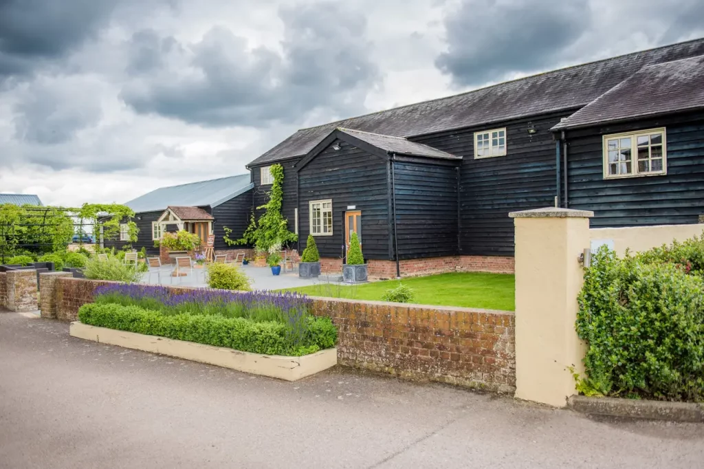 Rustic black barn venue in Arkley Village Hall, ideal for corporate events and receptions.