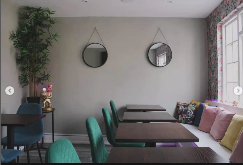 Stylish meeting space at Audrey's Jamaican Restaurant with colorful cushions for gatherings.