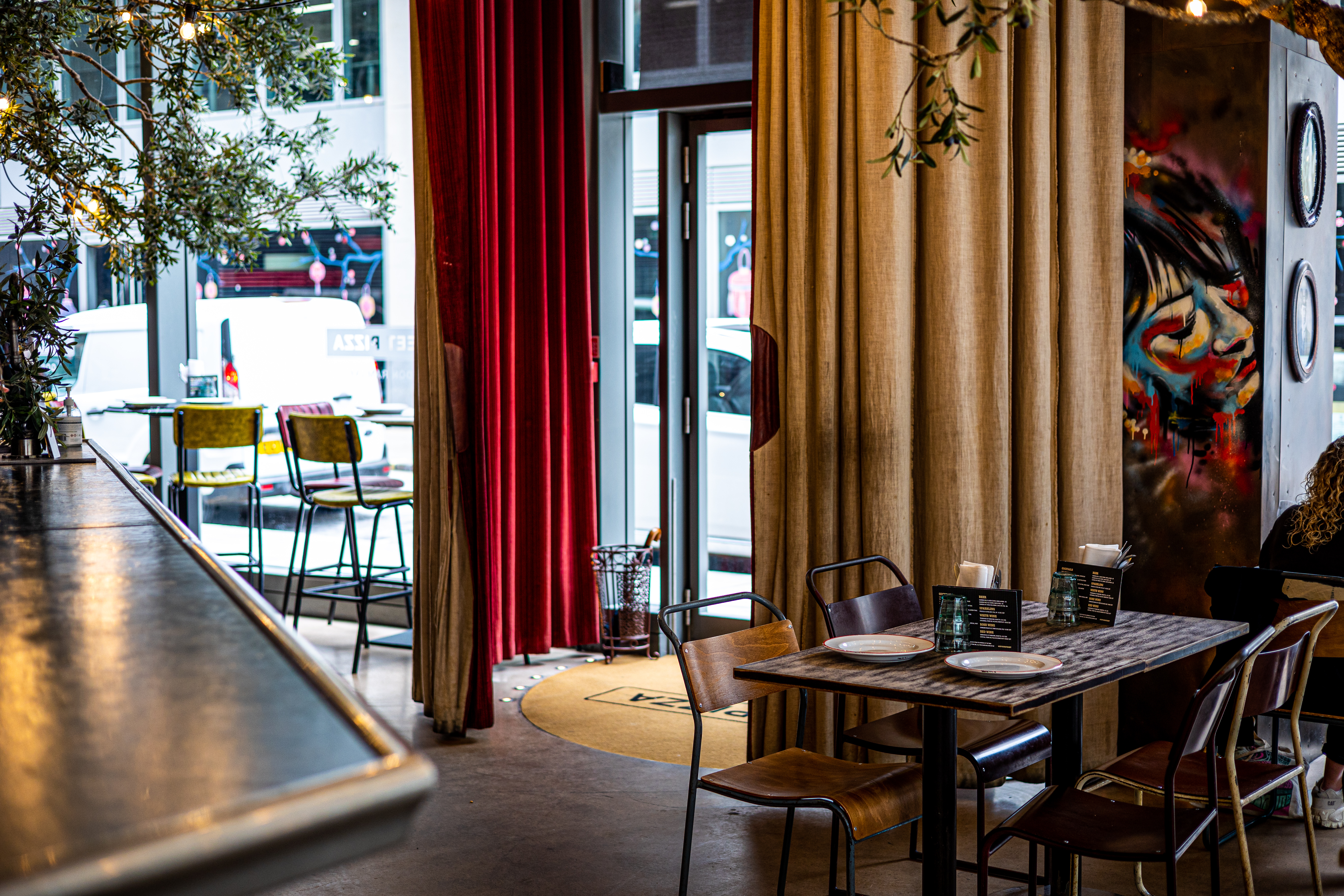 Stylish event space at Street Pizza St Paul's with cozy seating and vibrant decor.