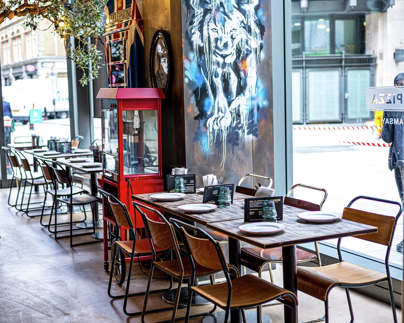 Stylish Street Pizza venue with vibrant art, perfect for casual meetings and events.