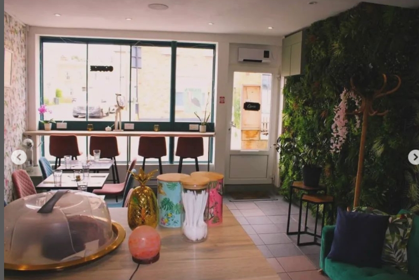 Stylish event space at Audrey's Jamaican Restaurant with greenery and modern decor.