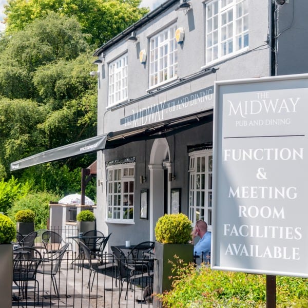 Charming pub venue with outdoor seating, ideal for meetings and events.