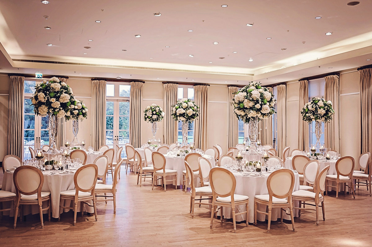Elegant event space with floral centerpieces for weddings and corporate events at The Hurlingham Club.