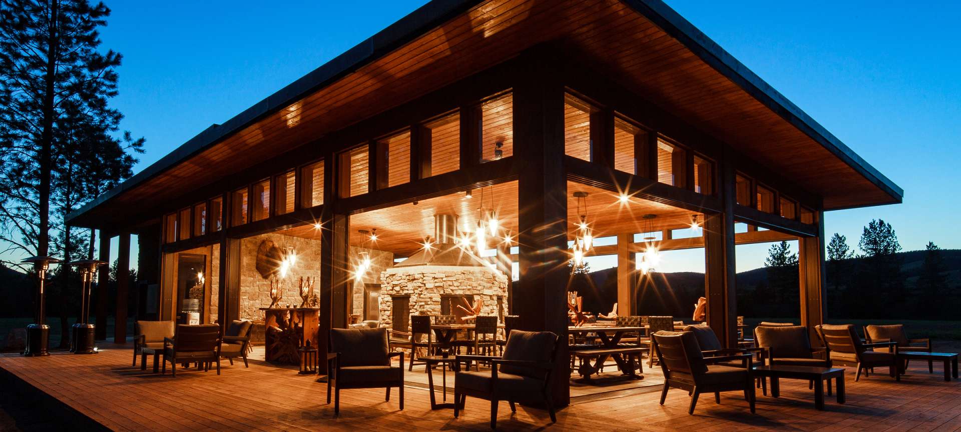 Bull Pen Patio at Paws Up: elegant event space with large windows and cozy fireplace.