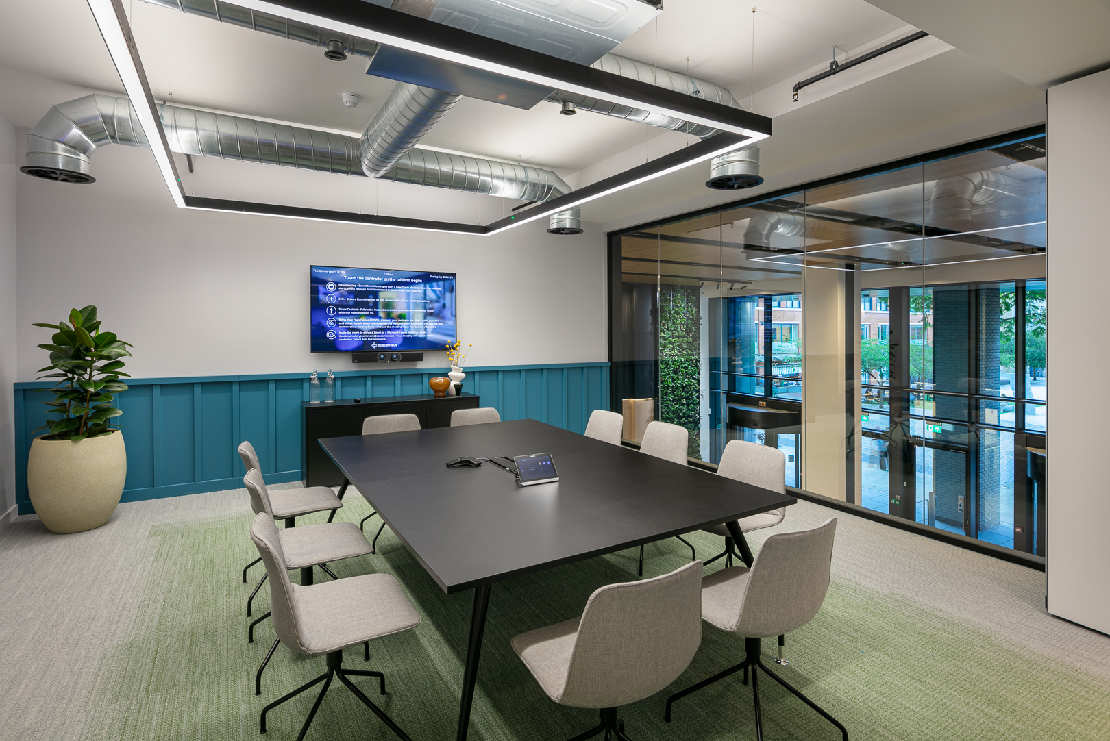 Modern meeting room with sleek black table, ideal for collaboration and presentations.