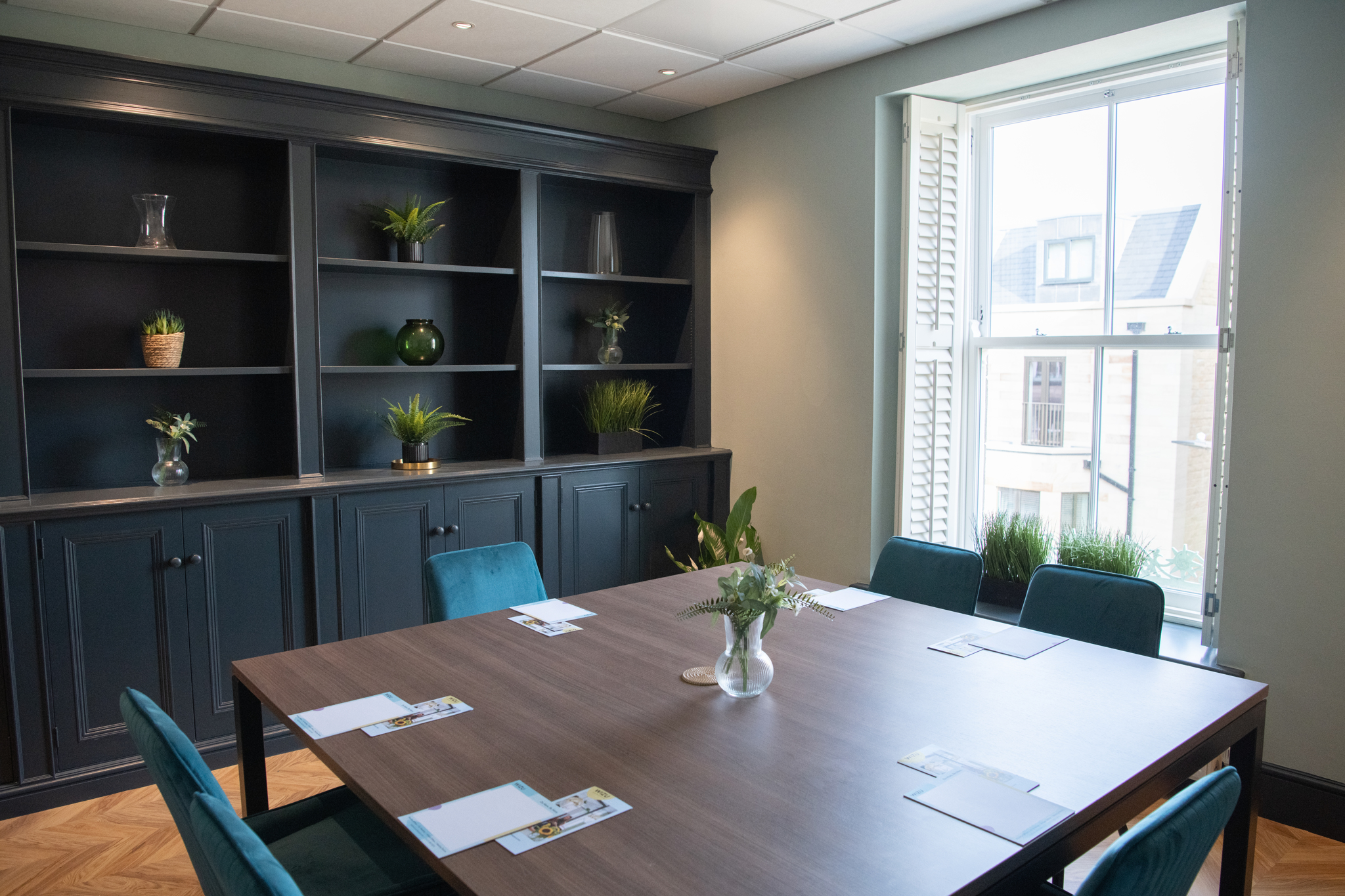 Oval Suite meeting room with sleek table setup for professional gatherings and brainstorming.