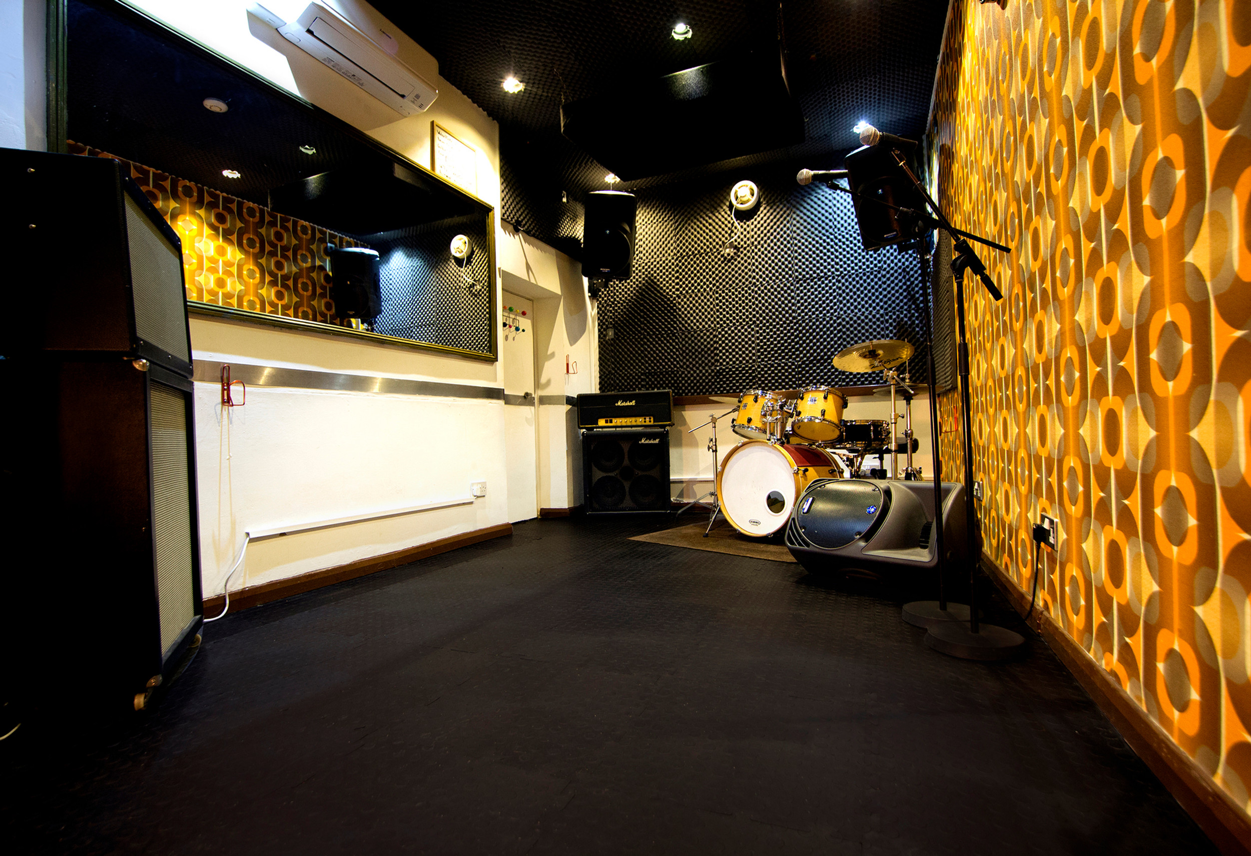 Recording studio in K-Town with vibrant walls, ideal for music events and workshops.