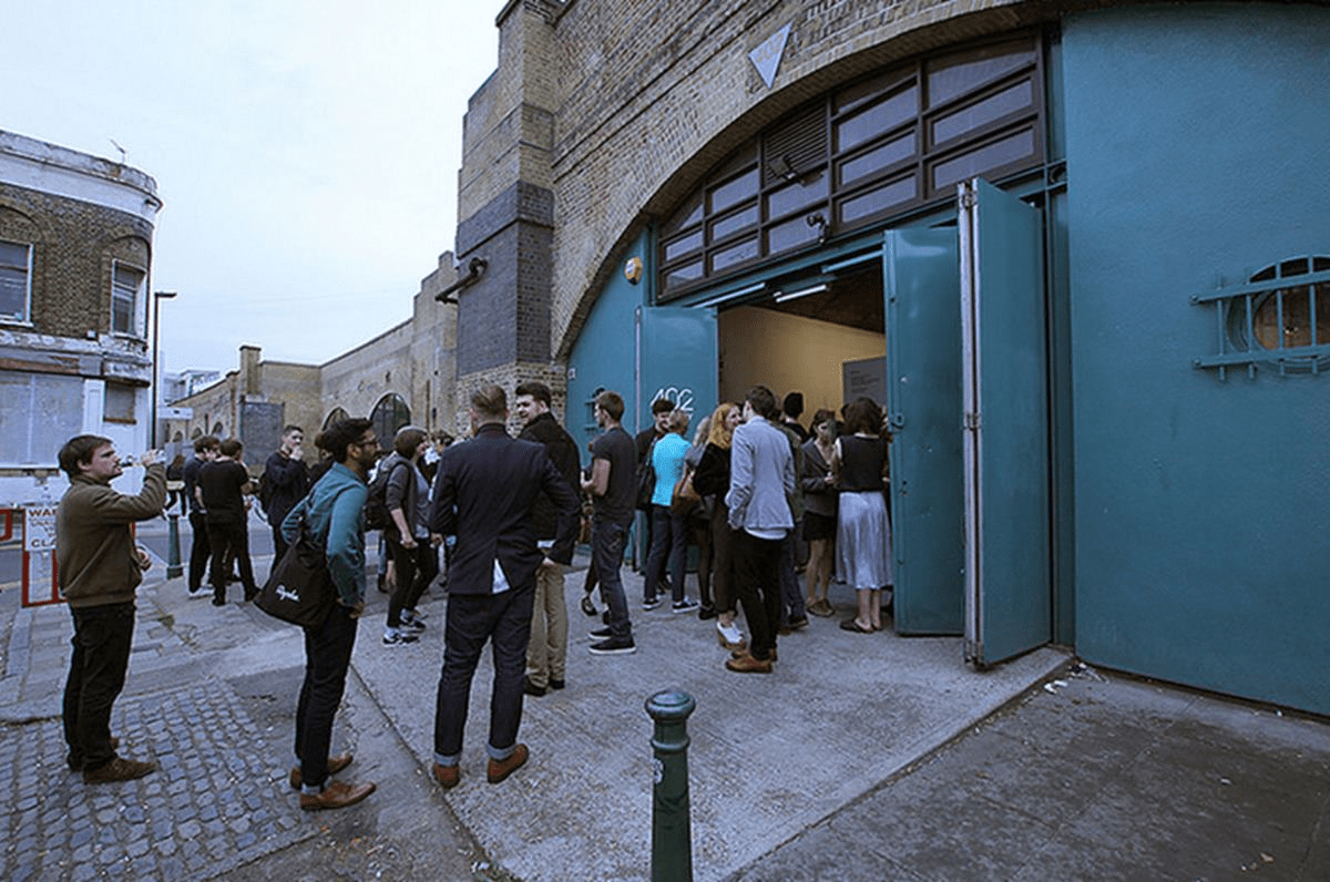 Outdoor bar space at Hoxton Arches with a lively queue for an engaging event.