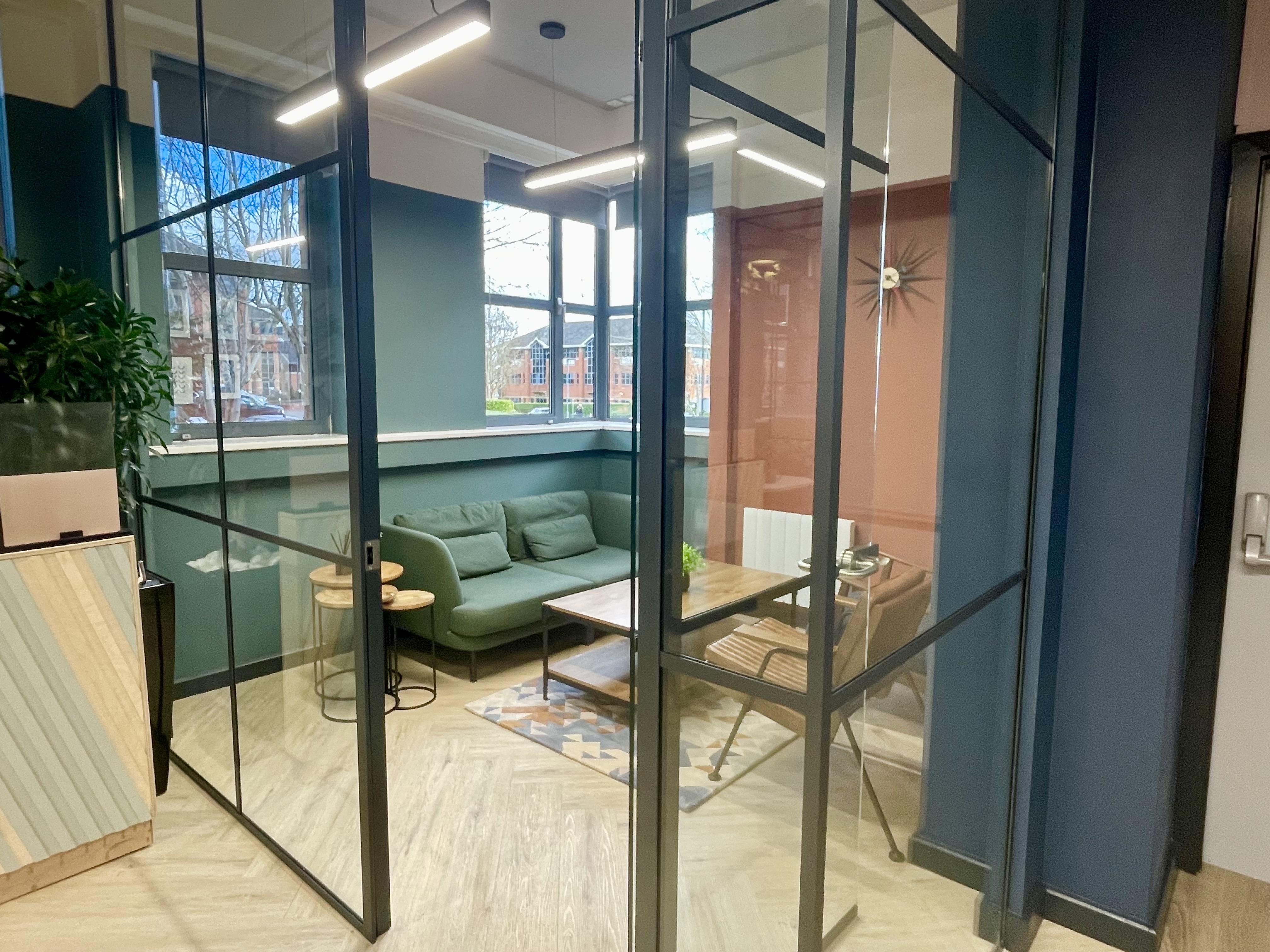 Modern meeting space with glass walls for collaboration in Wizu Workspace, Richmond.