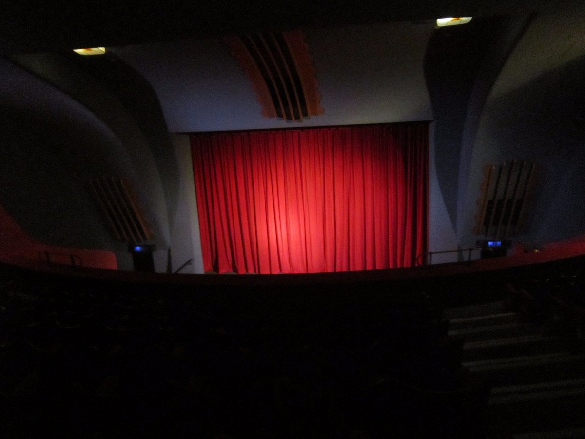 Red curtain stage in Rio Cinema, perfect for impactful performances and engaging events.