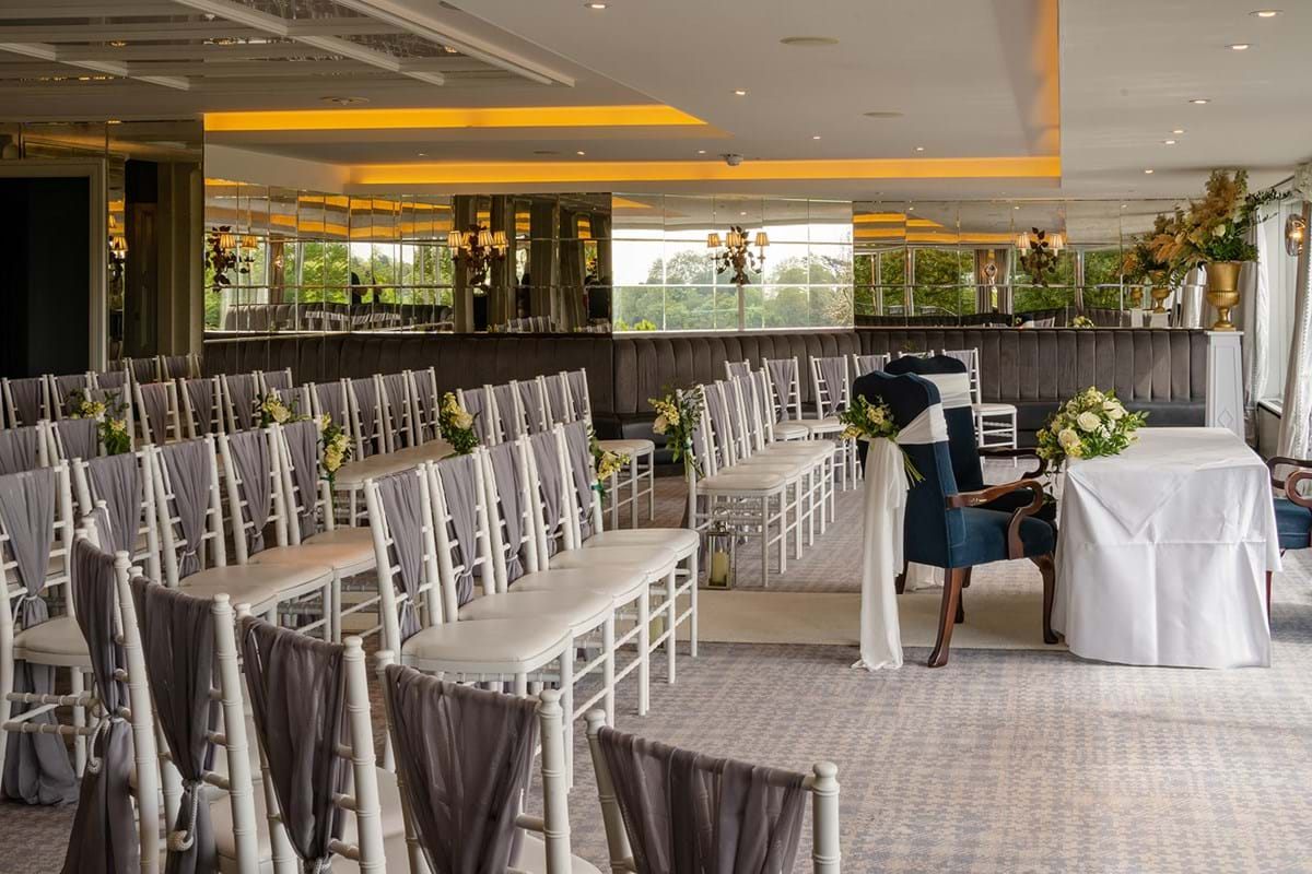 Elegant wedding venue with white chairs and floral accents at The Petersham Hotel.