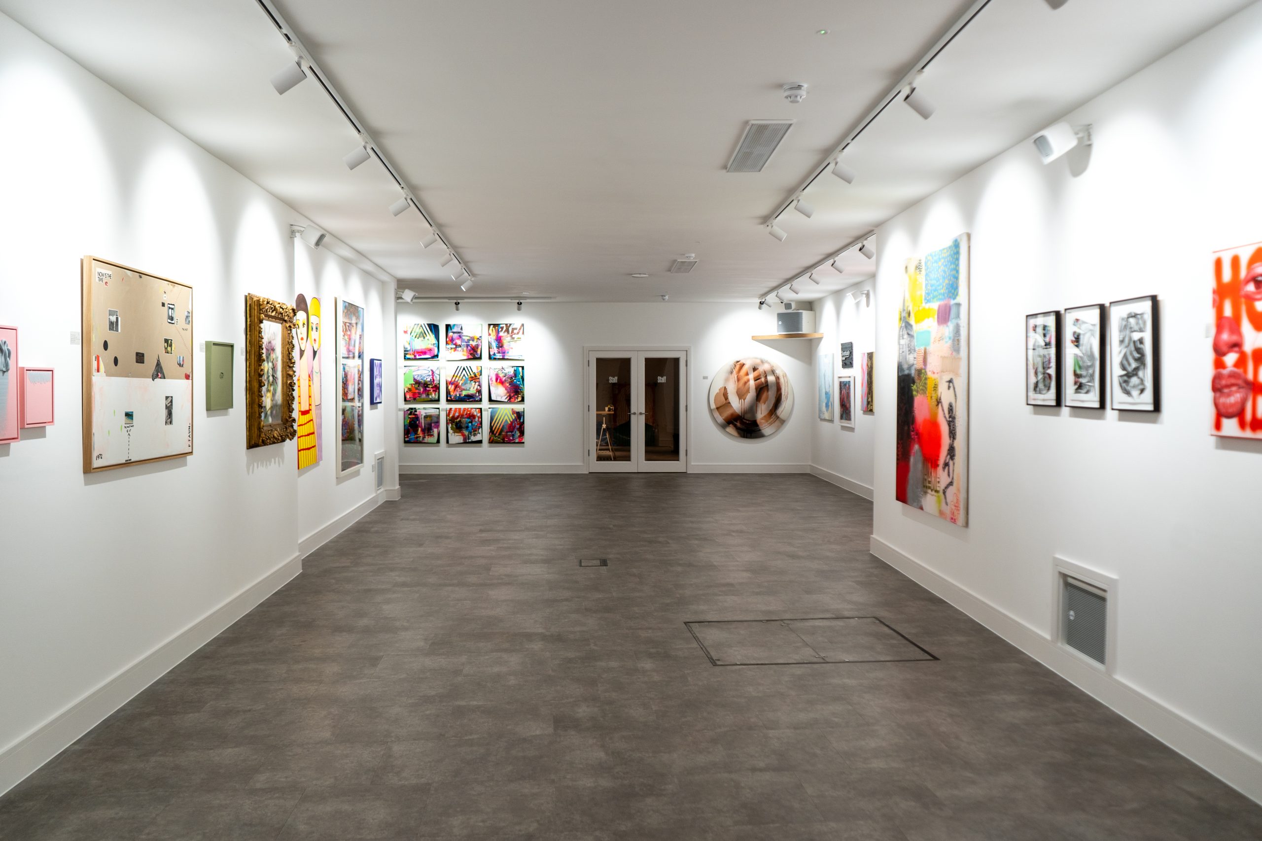 Spacious Helm Gallery exhibition hall with diverse artwork, ideal for art events and networking.