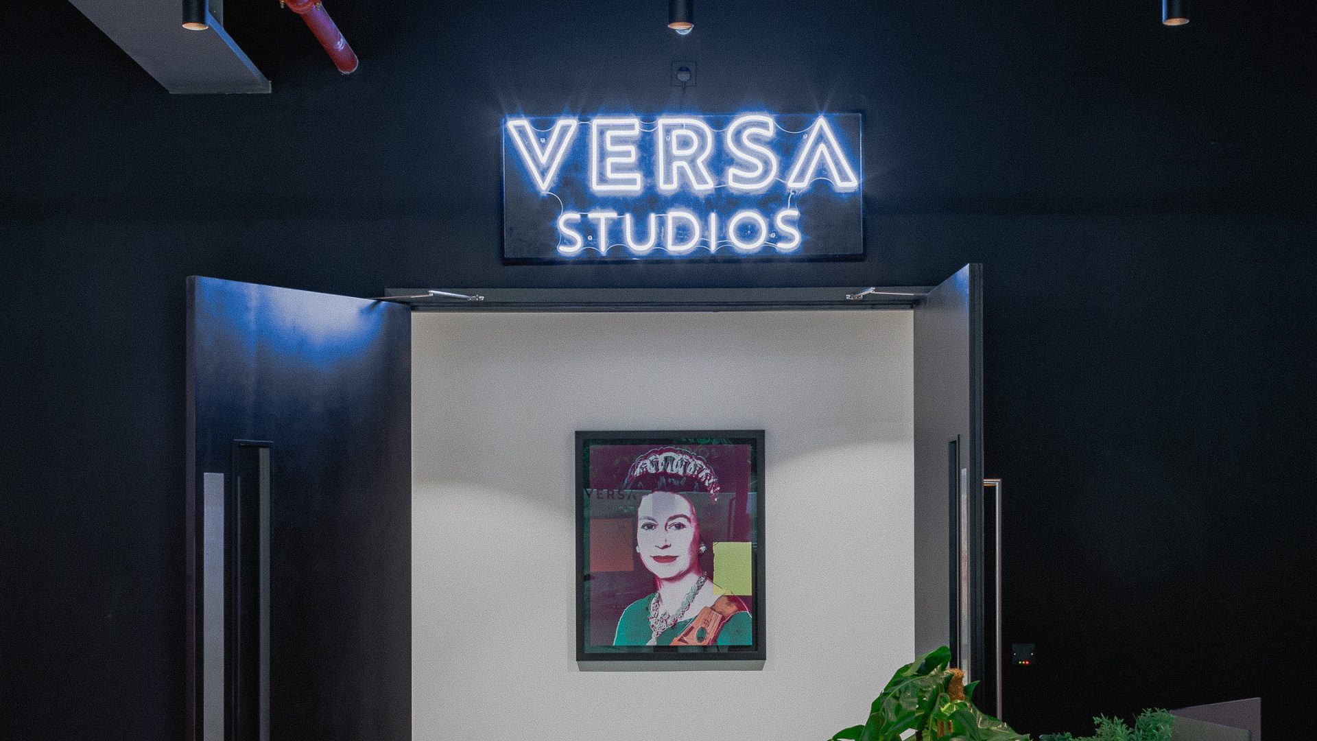 Modern entrance of VERSA Studios with neon sign, ideal for creative events and meetings.
