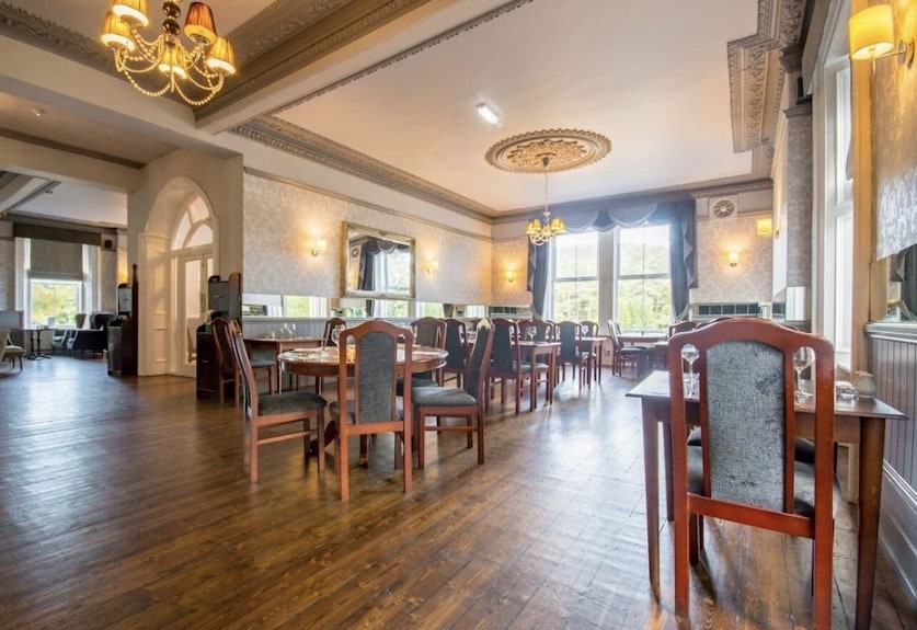 Elegant event space in Armstrong Manor with wooden flooring for corporate and social gatherings.