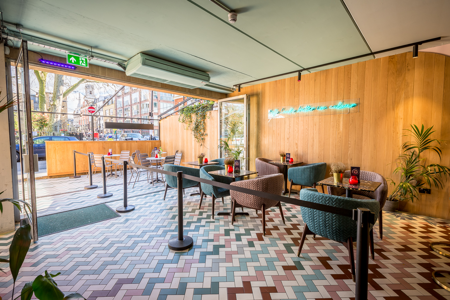 Main Bar & Terrace at Colours Hoxton, modern event space with vibrant flooring for gatherings.