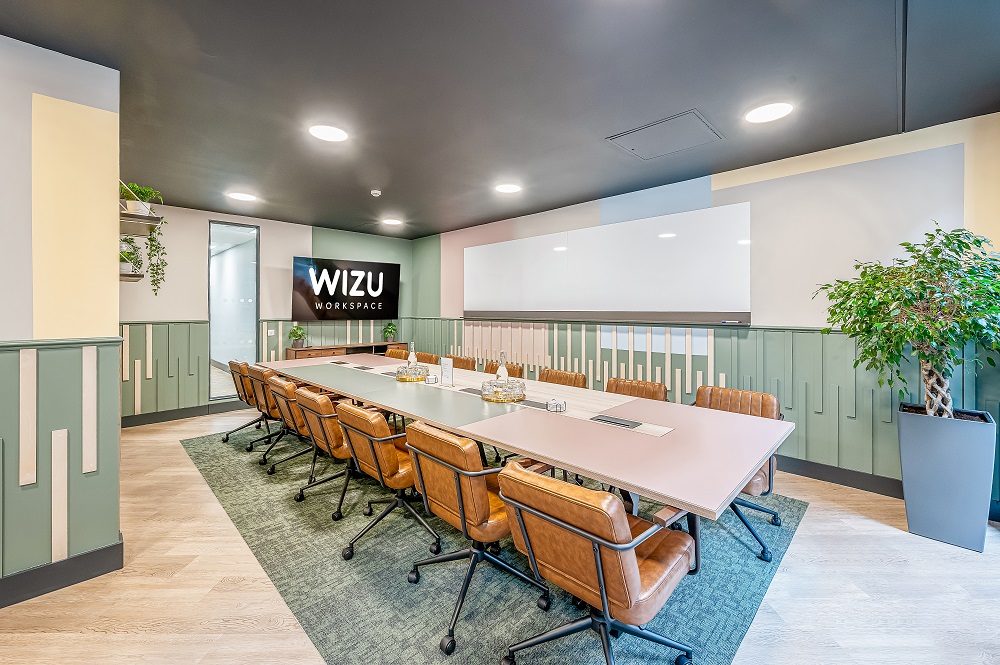 Modern meeting room in Wizu Workspace with sleek table, ideal for workshops and presentations.