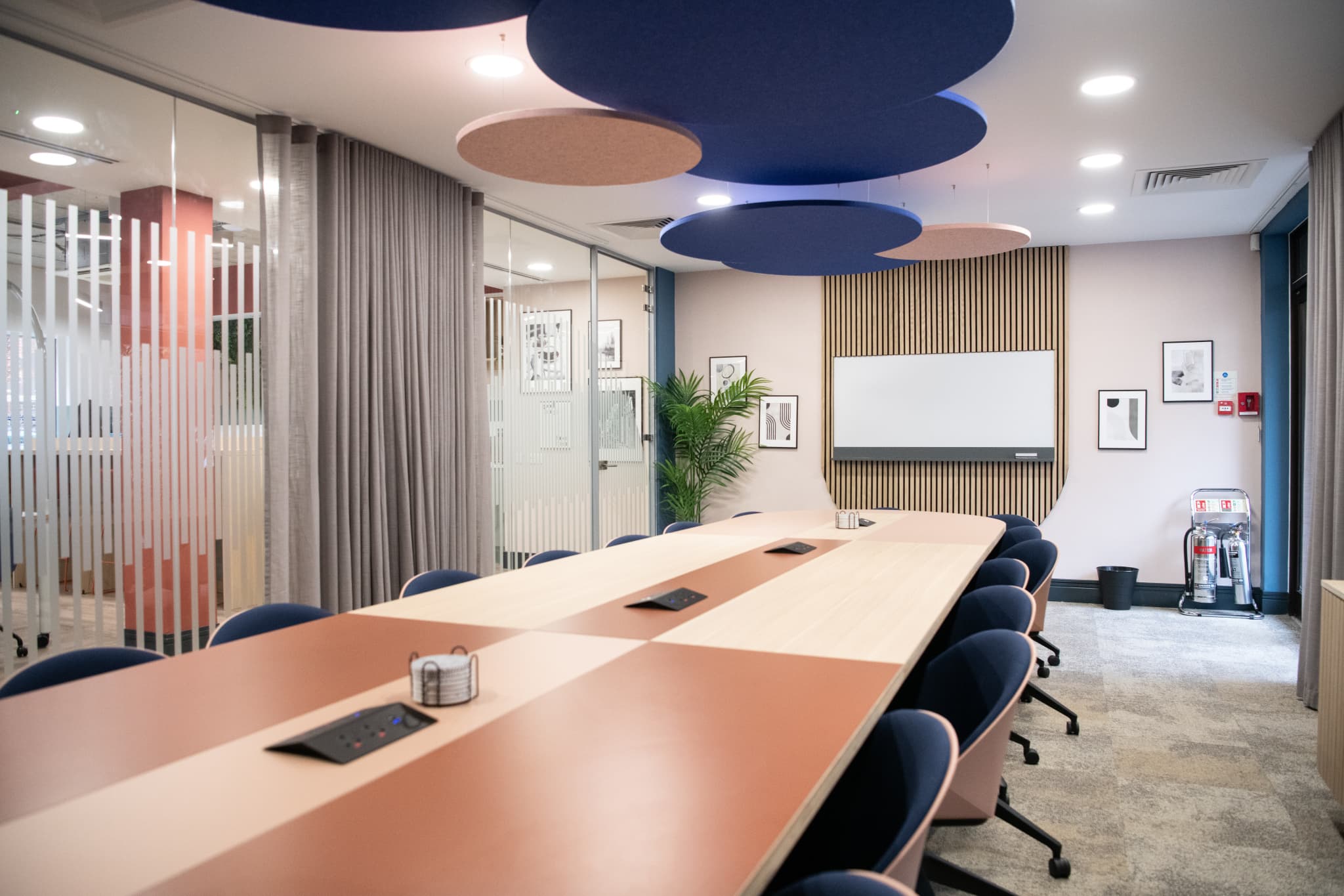 Modern Millennium Suite boardroom for executive presentations and strategy sessions.