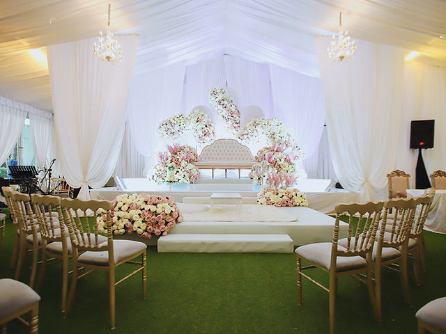 Chandelier Ballroom event space with elegant stage, ideal for weddings and upscale gatherings.