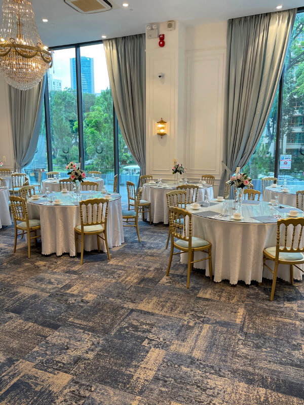 Elegant Chandelier Ballroom banquet setup with floral centerpieces for weddings and events.