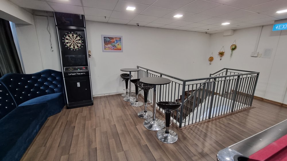 Urban Tavern Okio event space with plush blue couch, ideal for meetings and social gatherings.