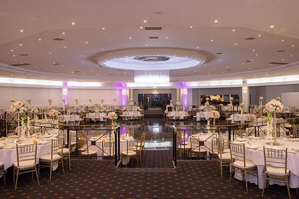 Elegant banquet hall with floral centerpieces, ideal for weddings and corporate events.