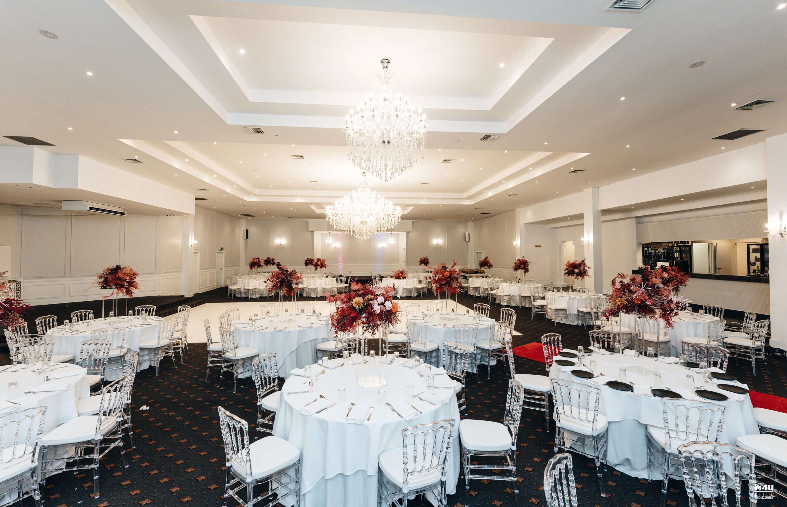 Elegant Pearl Ballroom with round tables, perfect for weddings and corporate events.