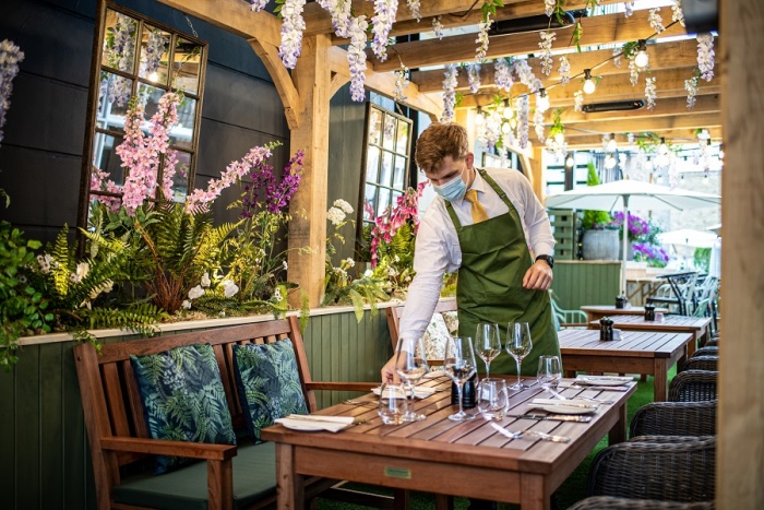 Outdoor dining setup at The Castle Hotel Windsor with vibrant floral decor for events.