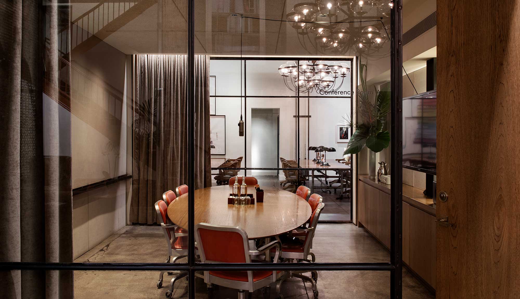 Modern podcast room with round table, ideal for meetings and brainstorming at NeueHouse.