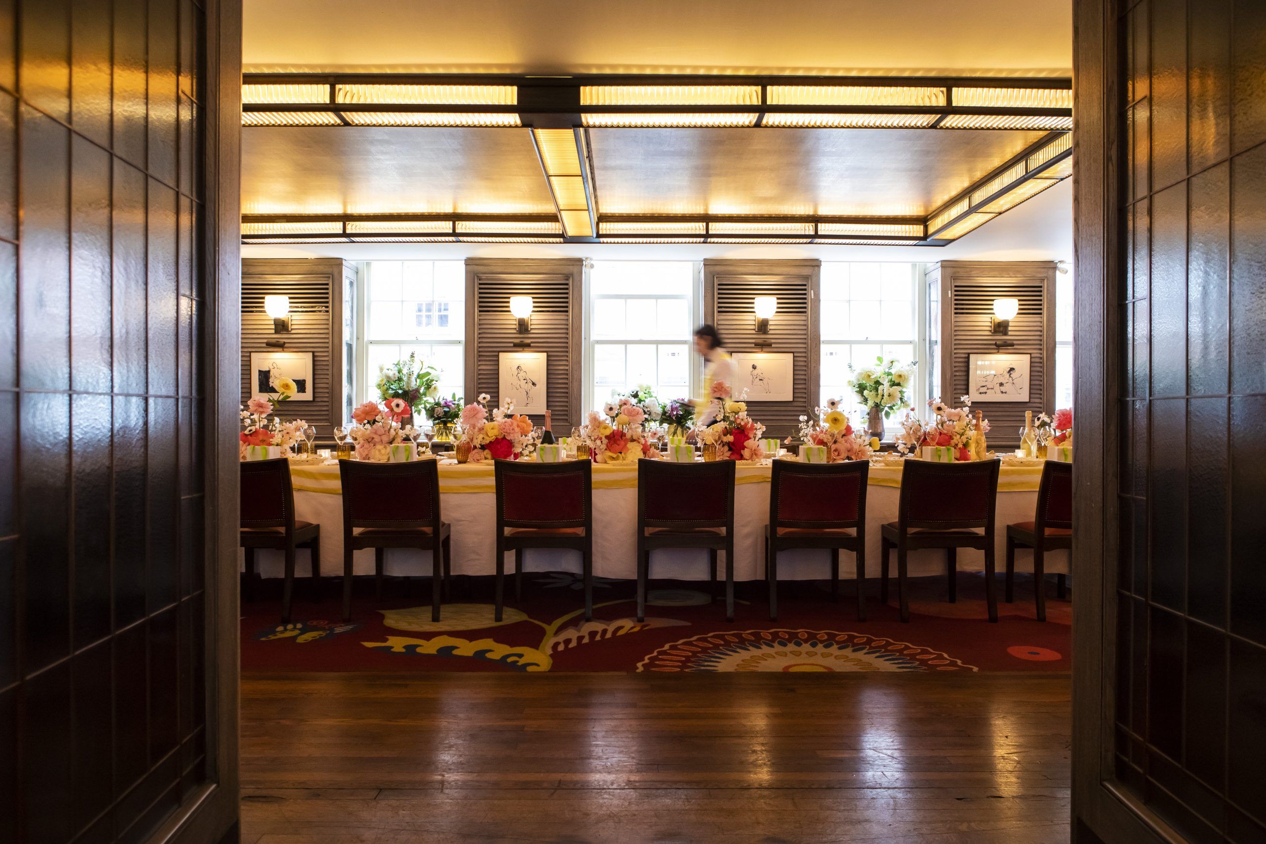 Elegant dining setup with floral centerpieces for networking event at The Emin.