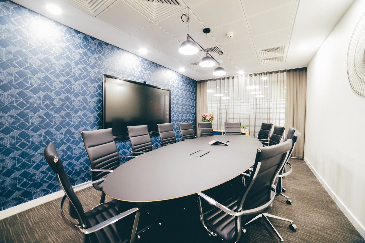 Modern conference room with oval table, ideal for productive meetings and presentations.