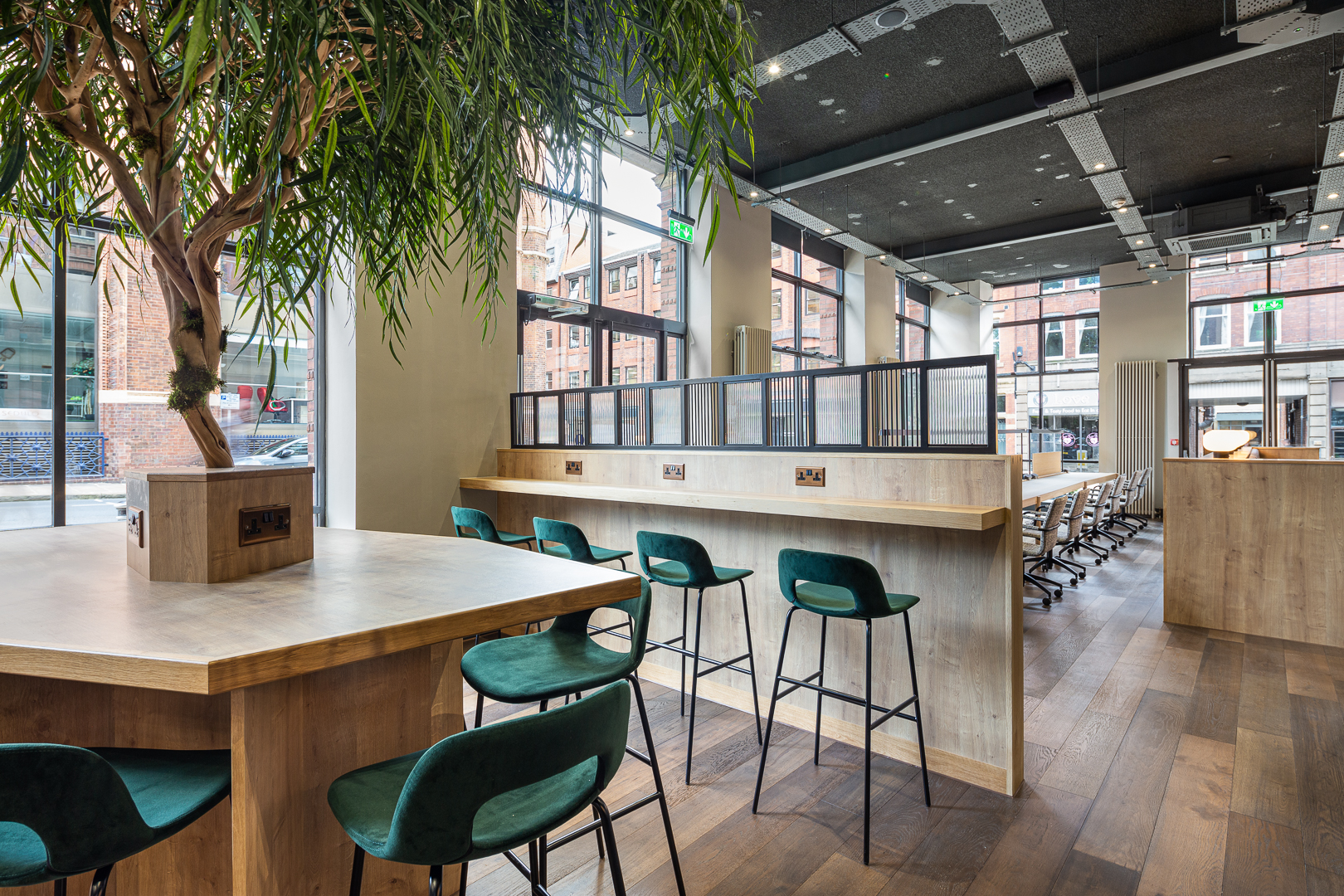 Modern coworking space with large windows, ideal for meetings and networking events.