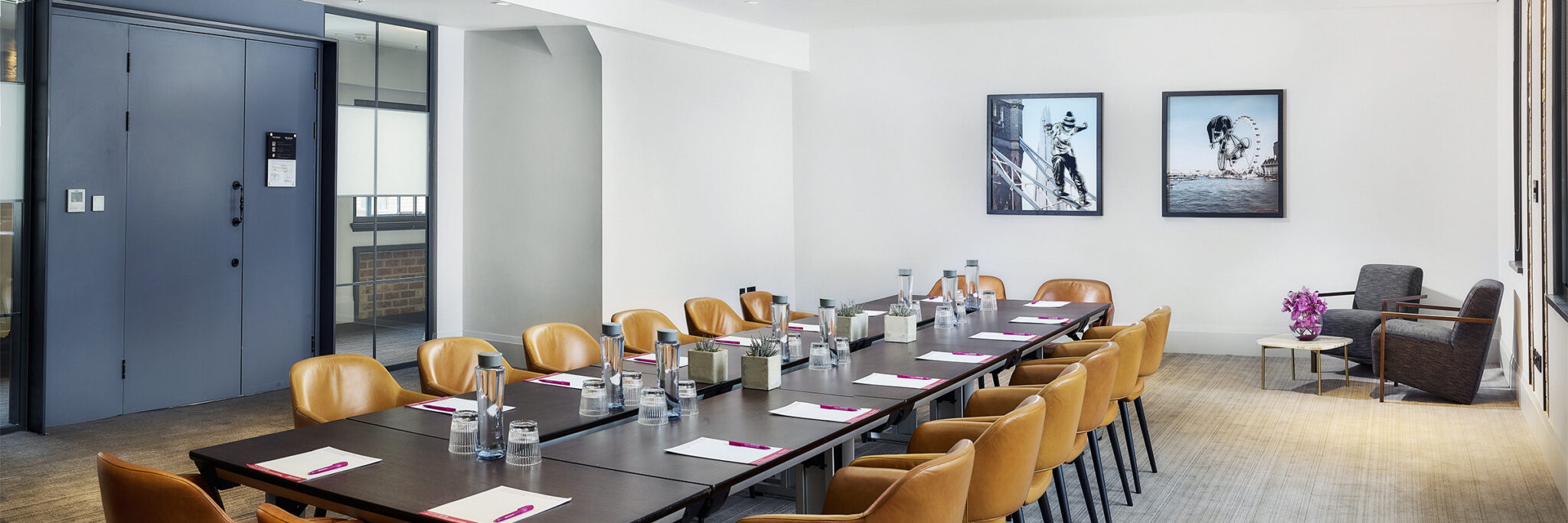 Modern meeting room in Etc.venues Manchester with leather chairs, ideal for professional events.