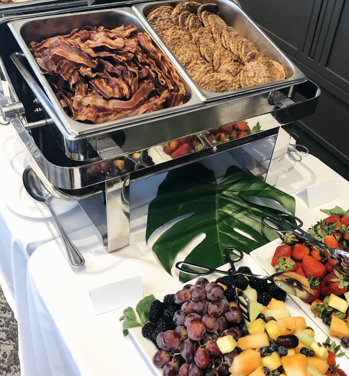 Elegant buffet setup with crispy bacon and fresh fruits at Vue on 50 event venue.