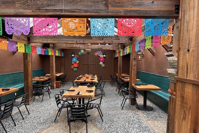 Outdoor terrace at Grand Palace Seafood Restaurant with colorful papel picado for festive events.