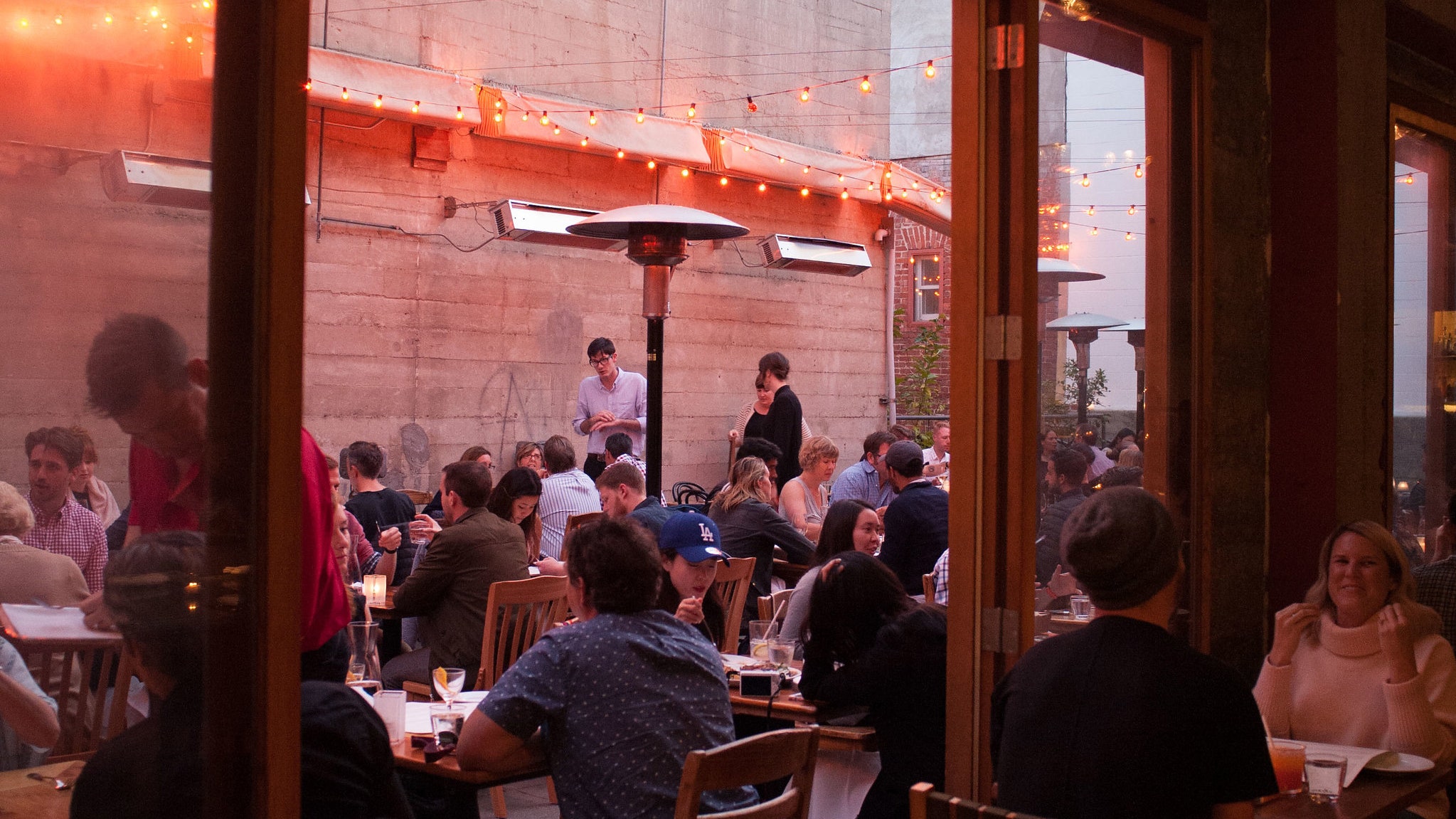 Outdoor terrace at Grand Palace Seafood Restaurant with string lights, perfect for events.