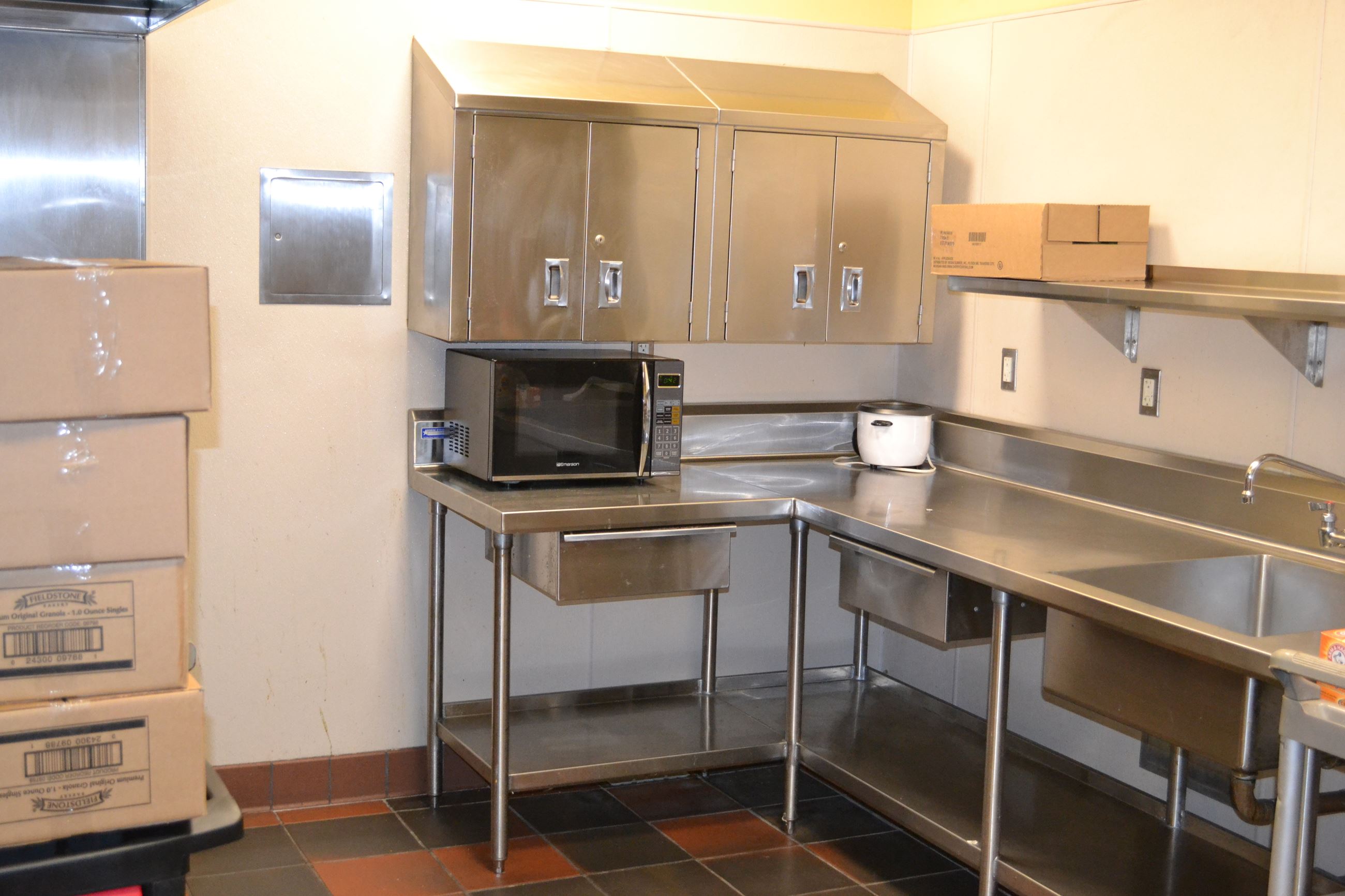 Activity Room kitchen at Bayshore Community Center, stainless steel surfaces for event catering.