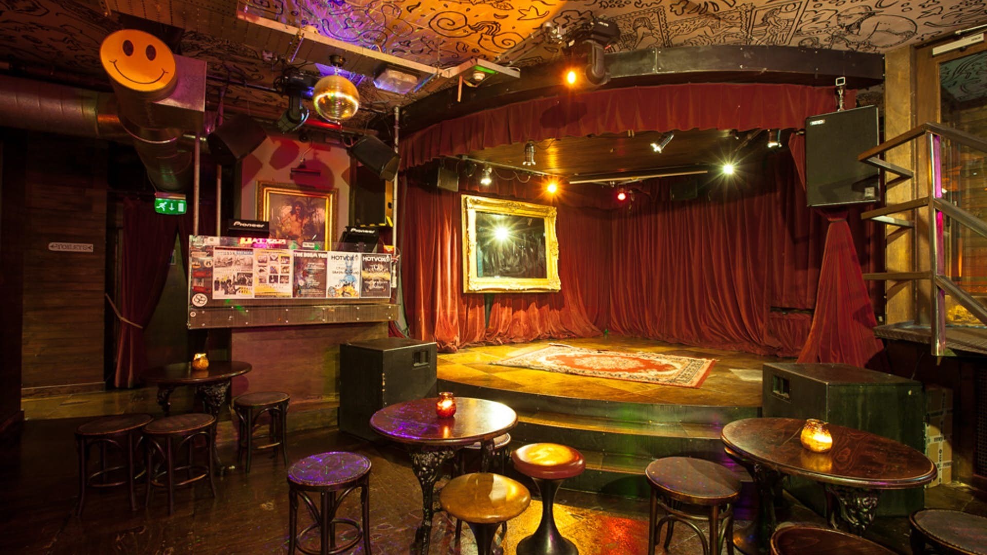 Vibrant music room with red curtains, perfect for live performances and creative events.