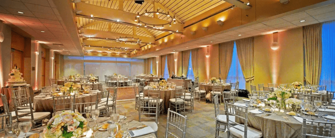 Elegant ballroom with floral centerpieces, perfect for weddings and corporate events.