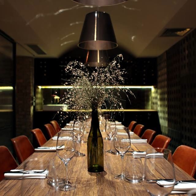 Sophisticated dining setup in Margaux with elegant floral centerpiece for corporate events.