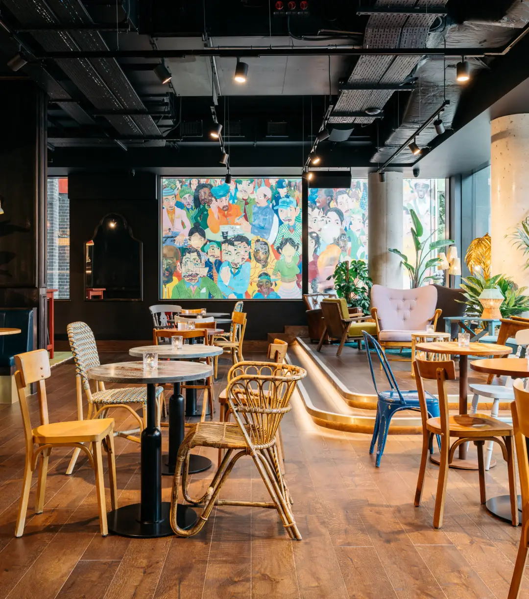 Vibrant Ruby Zoe Hotel bar with mural, ideal for creative meetings and gatherings.