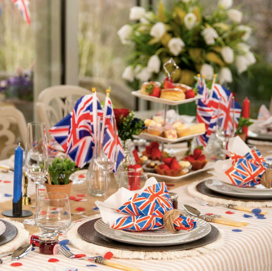 Tablescape with British flags and pastries for a festive tea party or holiday event.