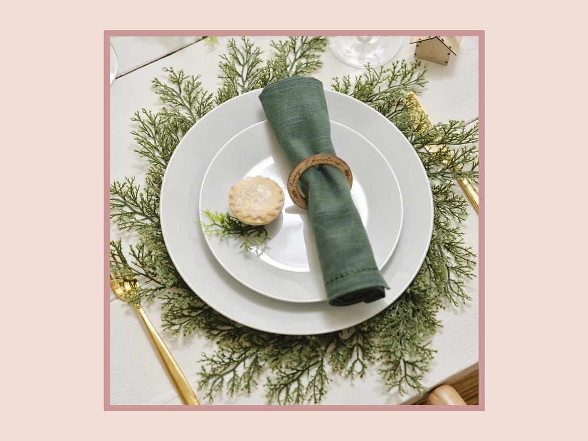 Elegant tablescape with white plate and greenery charger for upscale events.