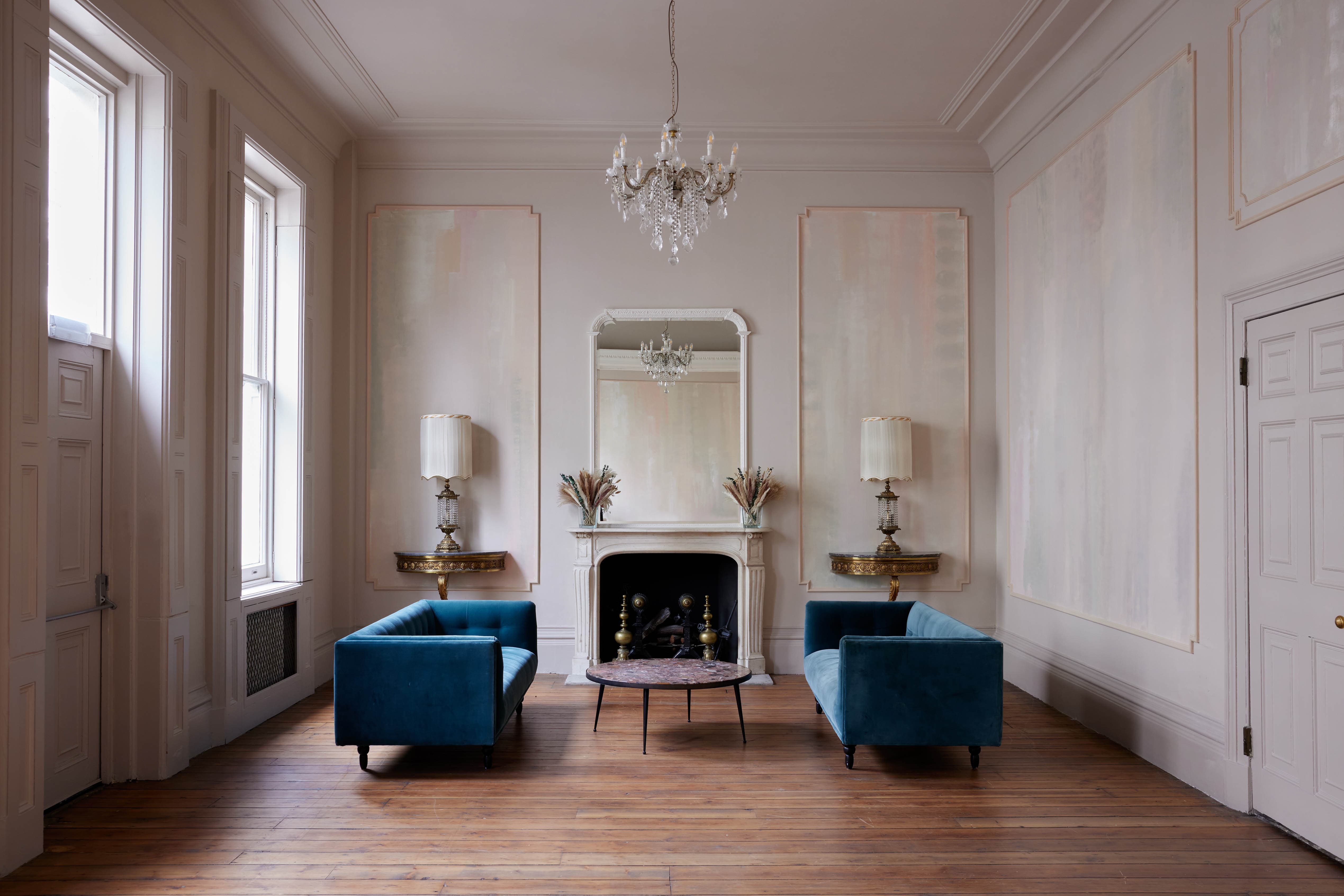 Elegant meeting space with blue couches, ideal for upscale gatherings and brainstorming sessions.